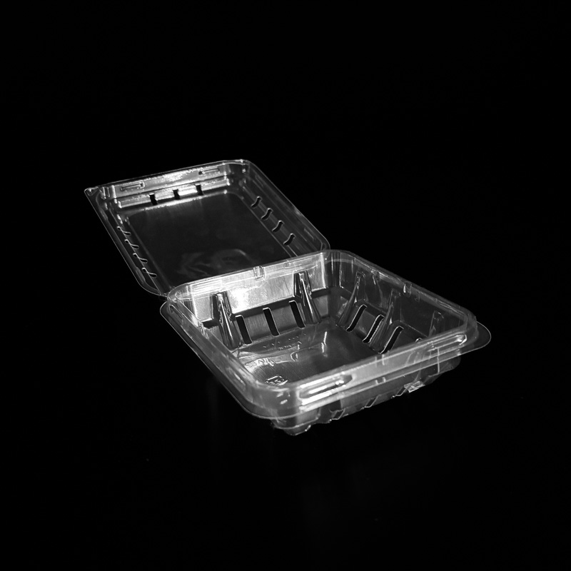 An open 6 ounce clear clamshell for blueberries.