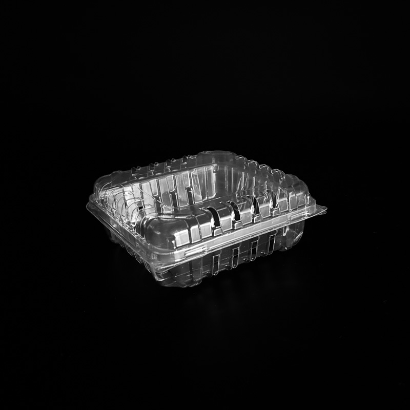 A clear 6 ounce clamshell with a black pad for blackberries.